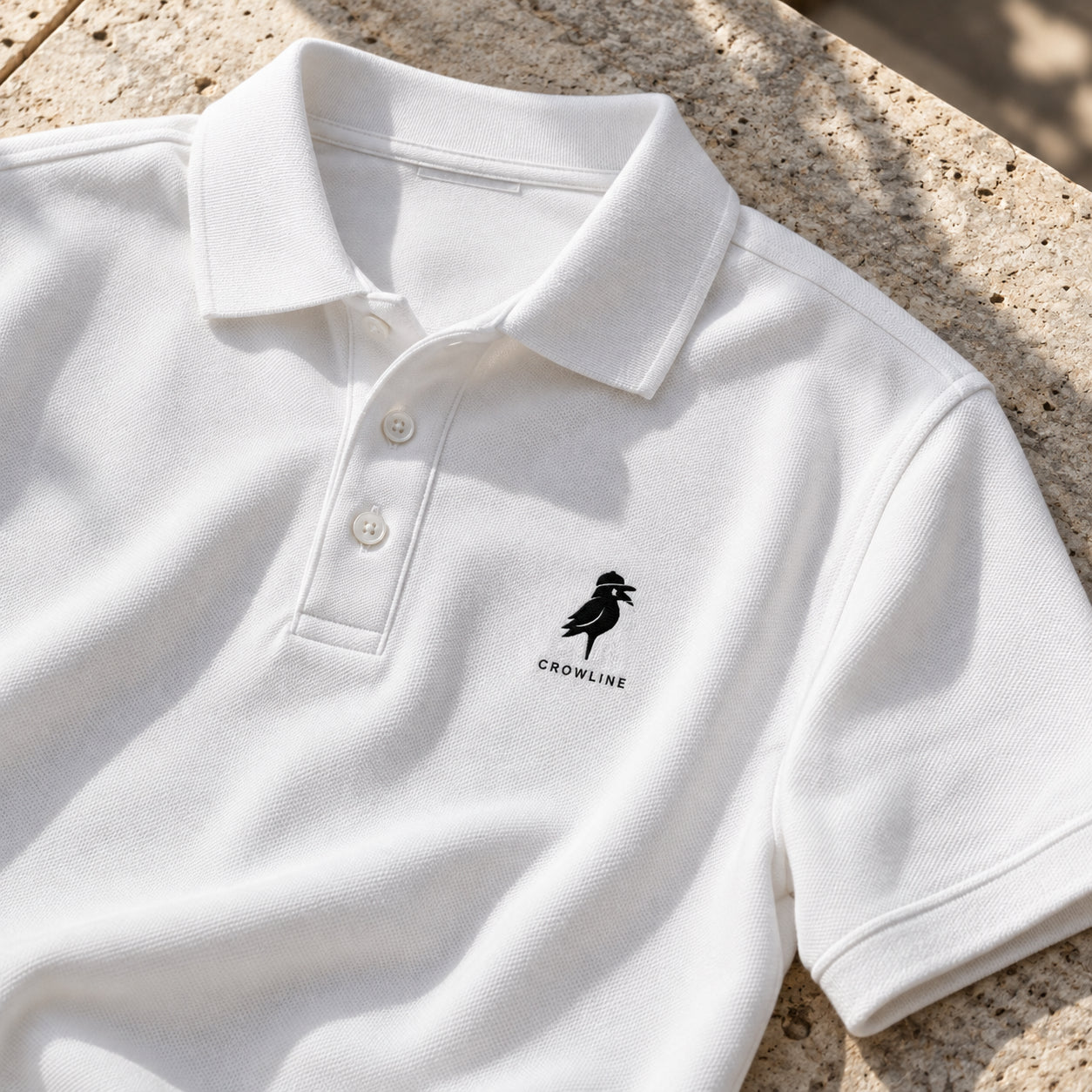Crow Polo in White — collar and placket detail