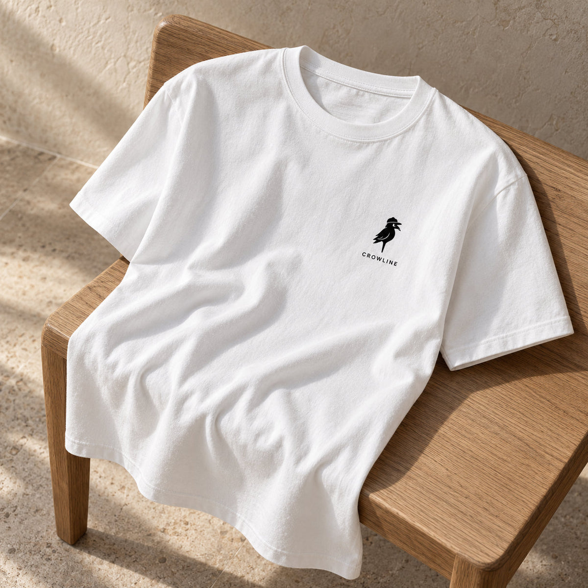 Crow Tee in White — folded detail